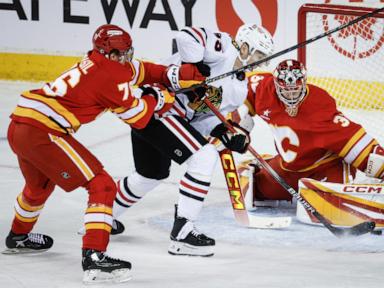 Flames get goals from 6 players in a 6-4 victory over the Blackhawks