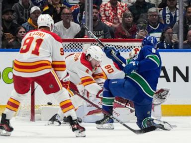 Zary scores in OT to lift Flames to 6-5 win over Canucks