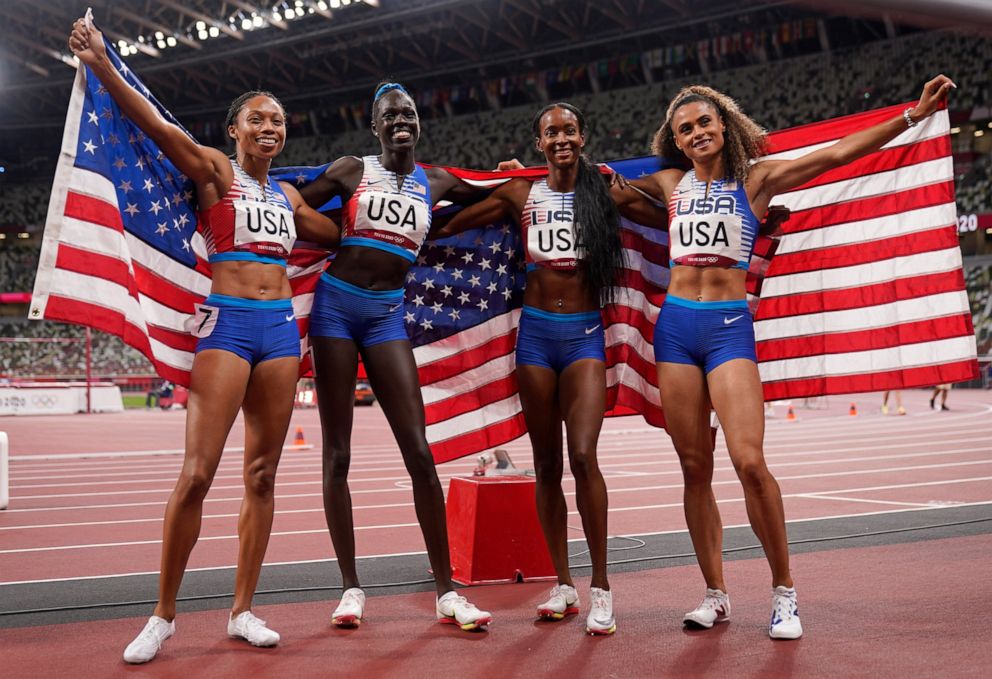 PHOTO: The United States team of Allyson Felix, Athing Mu, Dalilah Muhammad and Sydney Mclaughlin, from left, celebrate winning the gold medal in the final of the women's 4 x 400-meter relay at the 2020 Olympics, Saturday, Aug. 7, 2021, in Tokyo, Japan.