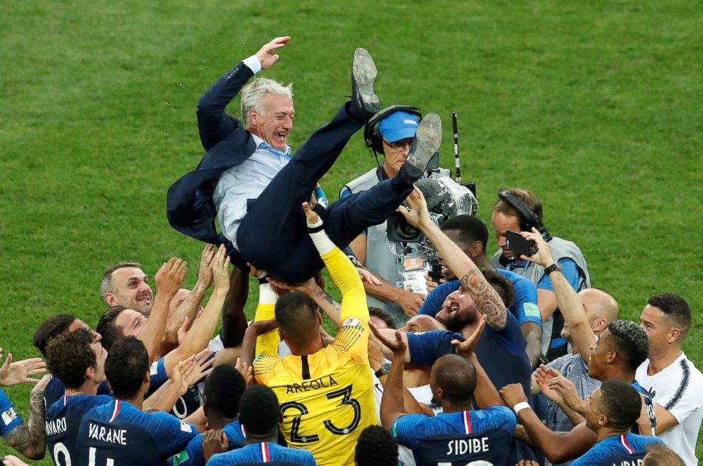 PHOTO: France coach Didier Deschamps is thrown into the air by his players as they celebrate after winning the World Cup on July 15, 2018, at Luzhniki Stadium in Moscow.