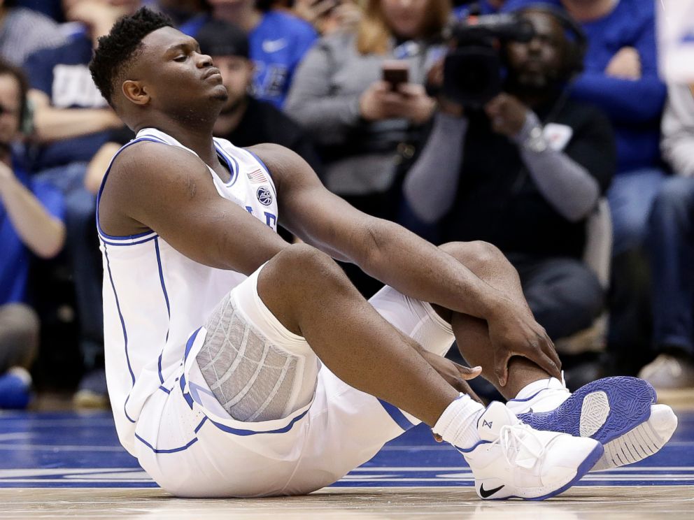 PHOTO: Dukes Zion Williamson sits on the floor following a injury during the first half of an NCAA college basketball game against North Carolina in Durham, N.C., Wednesday, Feb. 20, 2019.