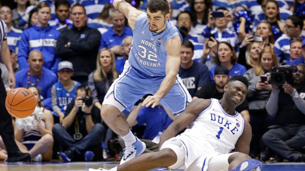 PHOTO: Duke's Zion Williamson (1) falls to the floor with an injury while chasing the ball with North Carolina's Luke Maye (32) during the first half of an NCAA college basketball game in Durham, N.C., Wednesday, Feb. 20, 2019. 