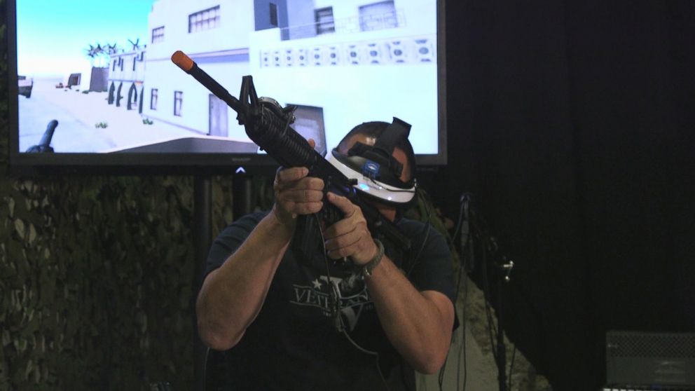 PHOTO: Chris Merkle holds a fake gun while undergoing a virtual reality therapy session that is allowing him to face aspects of his trauma.