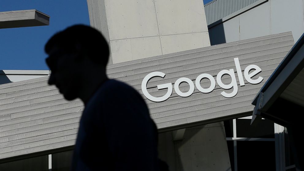 A man walks past a building on the Google campus in Mountain View, Calif.