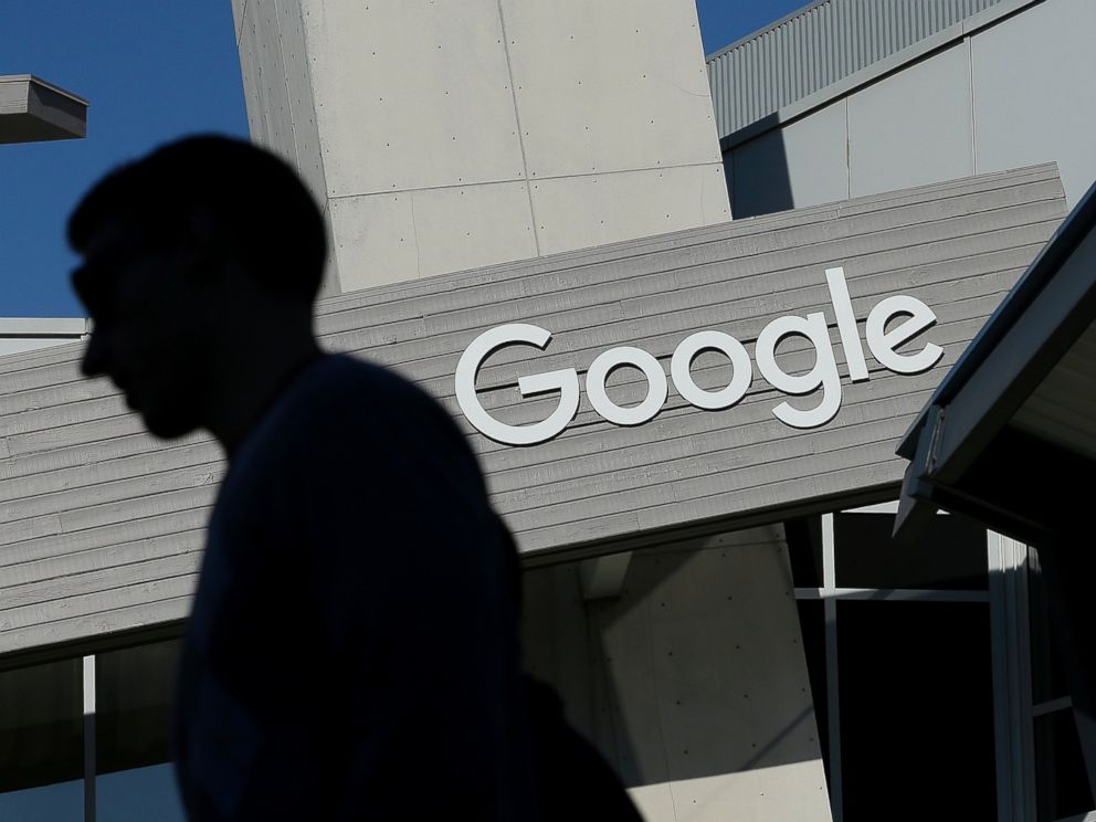 A man walks past a building on the Google campus in Mountain View, Calif.