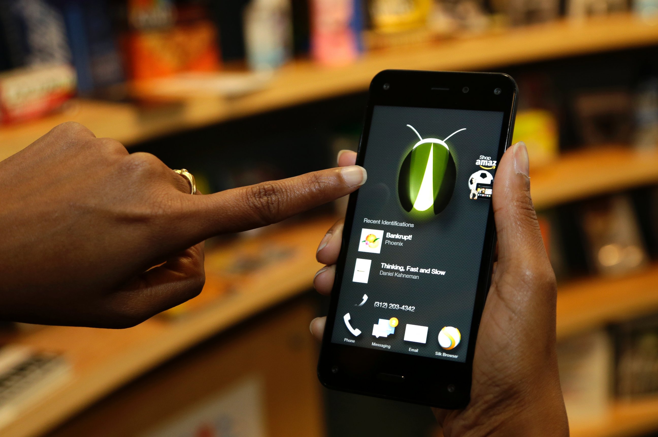 PHOTO: The new Amazon Fire Phone's Firefly feature, which lets the user take a photo of objects, numbers, artwork or books and have the phone recognize the item, is demonstrated in Seattle on June 18, 2014. 