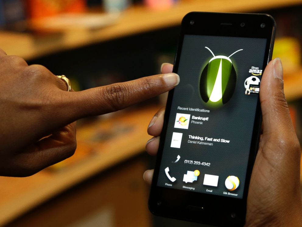 PHOTO: The new Amazon Fire Phones Firefly feature, which lets the user take a photo of objects, numbers, artwork or books and have the phone recognize the item, is demonstrated in Seattle on June 18, 2014.