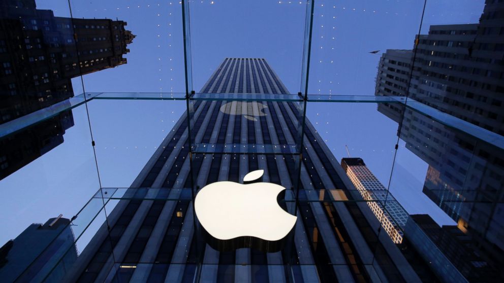 The Apple logo hangs in the glass box entrance to the company's Fifth Avenue store in New York, Sept. 5, 2014.