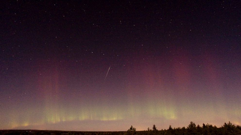 PHOTO: A Draconid meteor and Northern Lights are observed near Skekarsbo at the Farnebofjardens national park, 150 kilometers north of Stockholm, Oct. 8, 2011.