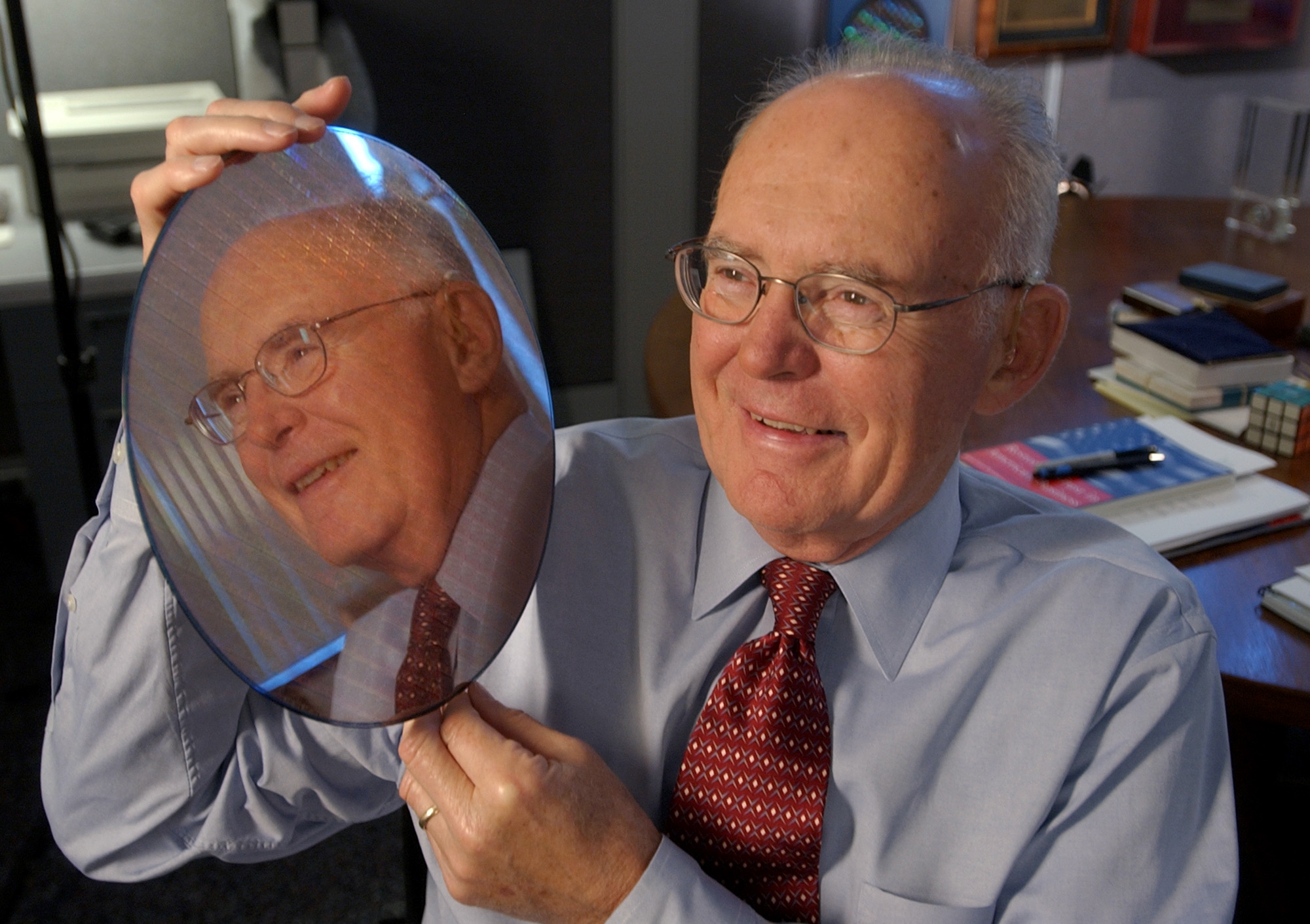 PHOTO: Intel Corp. co-founder Gordon Moore holds up a silicon wafer at Intel headquarters in Santa Clara, Calif., March 9, 2005. 