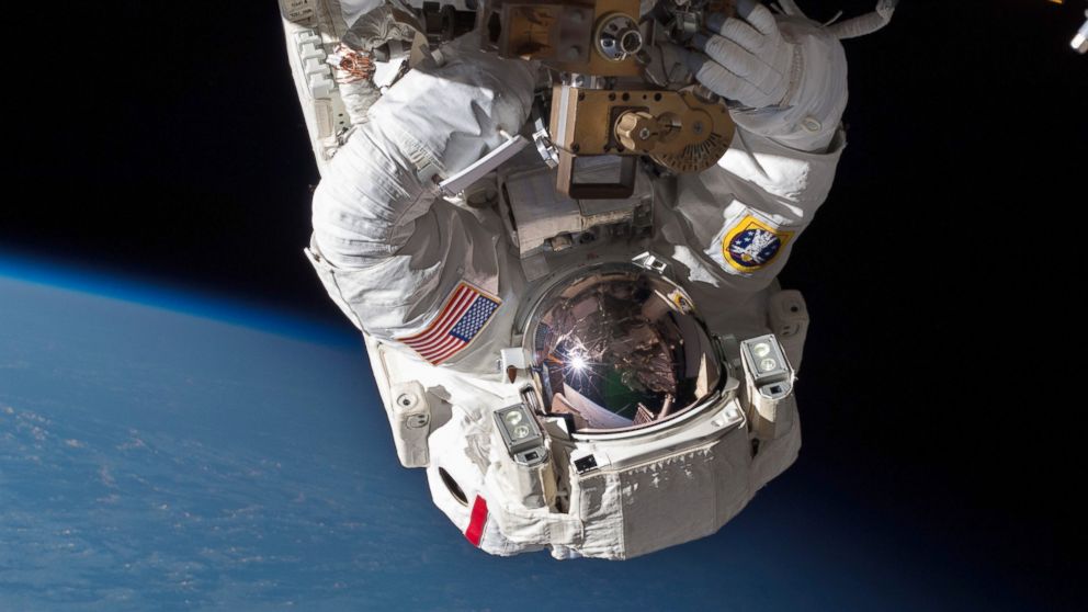 PHOTO: Chris Cassidy performs a space walk to inspect and replace a pump controller box on the ISS