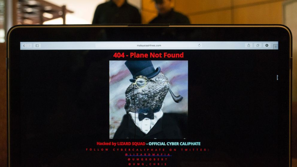 PHOTO: Workers stand behind a computer which shows the hacked website of Malaysia Airlines, at a cafe in Petaling Jaya outside Kuala Lumpur, Malaysia, Jan. 26, 2015.
