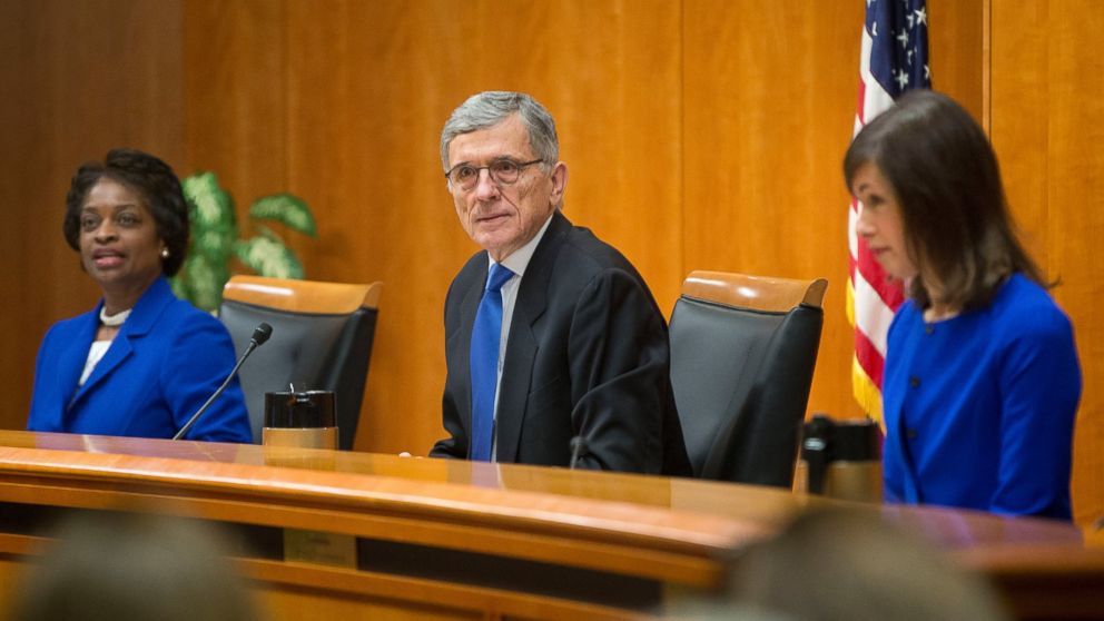 Federal Communication Commission (FCC) Chairman Tom Wheeler, center, with FCC Commissioners Mignon Clyburn, left, and Jessica Rosenworcel, before the start of their open hearing in Washington, Feb. 26, 2015. 