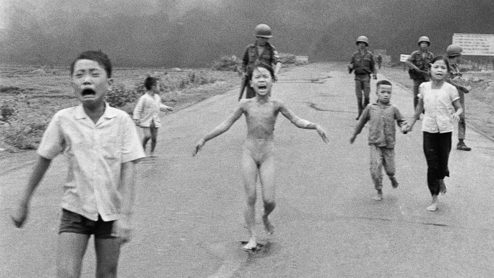 This June 8, 1972 file photo shows South Vietnamese forces following after terrified children, including 9-year-old Kim Phuc, center, as they run down Route 1 near Trang Bang after an aerial napalm attack on suspected Viet Cong hiding places. 
