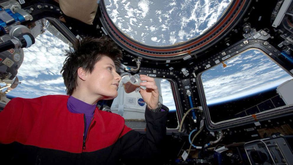 In this photo posted on Twitter, May 3, 2015, and provided by NASA, Italian astronaut Samantha Cristoforetti sips espresso from a cup designed for use in zero-gravity, on the International Space Station.