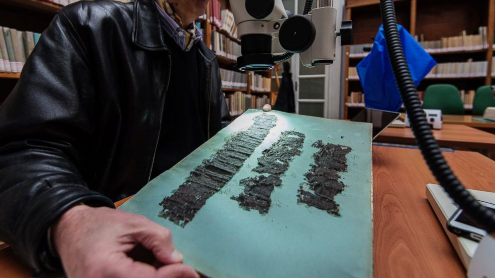 David Blank, professor of Classics from the University of California, looks through a microscope at ancient papyrus at the Naples National Library in Naples, Italy on Jan. 20, 2015. 