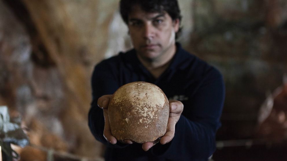Dr. Omry Barzilai of Israel's Antiquities Authority holds an ancient skull found inside a cave near the Israeli northern city of Nahariya, Jan. 28, 2015.