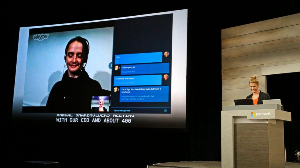 Microsoft Corp.'s Ashley Frank, right, speaks to a colleague in Germany, on-screen at left, using a beta feature of the company's Skype Internet telecommunications software that translates spoken foreign language to both text and speech, Dec. 3, 2014, in Bellevue, Wash.