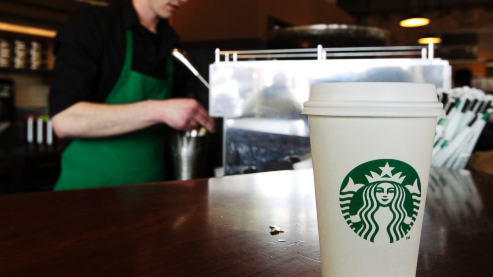 PHOTO: A Starbucks drink waits for a customer to pick it up as a barista prepares another, in Seattle.