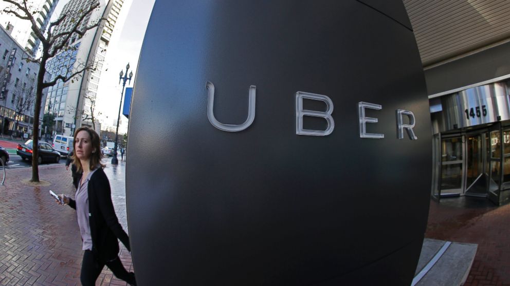 A woman leaves the headquarters of Uber in San Francisco in this Dec. 16, 2014 file photo.