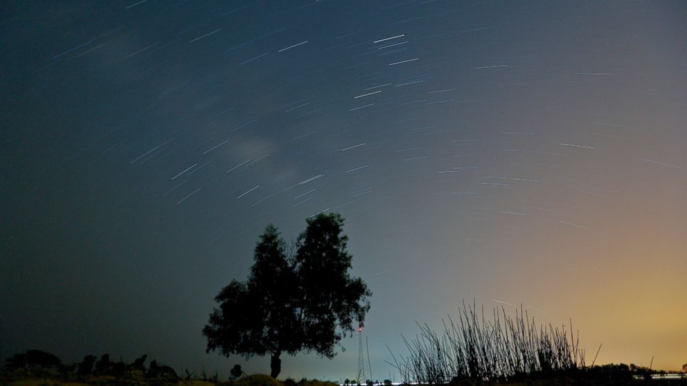 PHOTO: A long exposure photograph shows stars and meteors illuminating the sky during the Lyrid meteor shower in Yangon, Myanmar on April 23, 2015. 