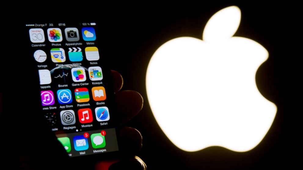 An illustration of an iPhone held up in front of the Apple logo. Some users have reported a problem with Apple's iOS 9.3 update.
