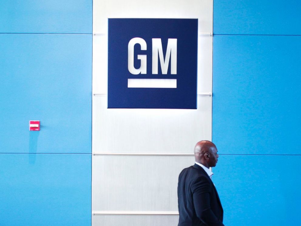 PHOTO: A person walks past the GM logo at the General Motors Technical Center on June 5, 2014 in Warren, Mich.