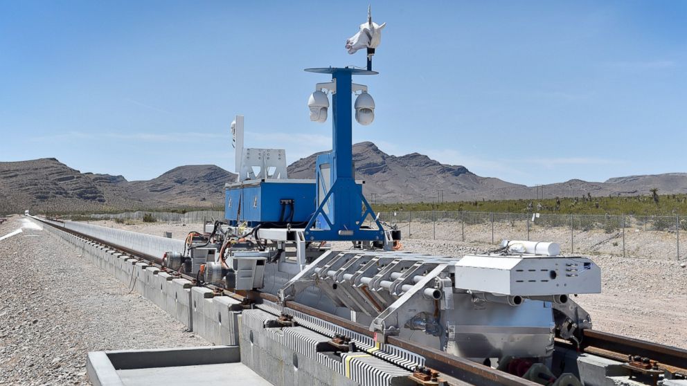PHOTO: A recovery vehicle and a test sled sit on rails after the first test of the propulsion system at the Hyperloop One Test and Safety site on May 11, 2016 in Las Vegas.