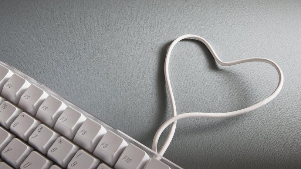 Image of computer keyboard with heart-shape wire.