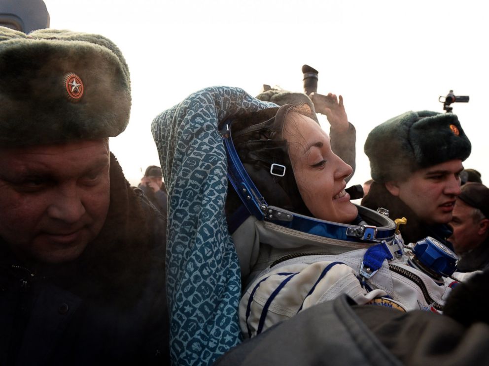 PHOTO: Russias space agency ground personnel help Russian cosmonaut Yelena Serova after the landing of the Soyuz TMA-10M capsule in the city Karaganda in Kazakhstan, March 12, 2015.