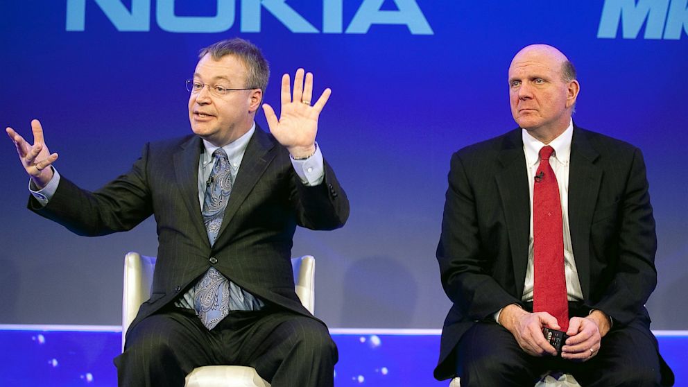 Stephen Elop, chief executive officer of Nokia Oyj, left, speaks as Steve Ballmer, chief executive officer of Microsoft Corp., listens while on stage at the Nokia capital markets day in London, U.K., Feb. 11, 2011.
