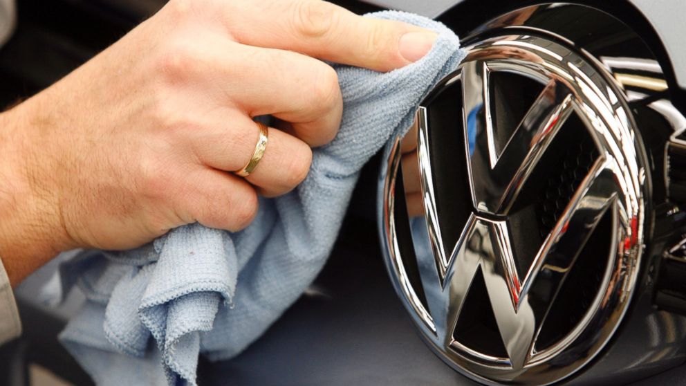 A worker polishes a Volkswagen logo on a Golf 6 automobile during final inspection in the Volkswagen AG factory in Wolfsburg, Germany in this Nov. 14, 2008 file photo.