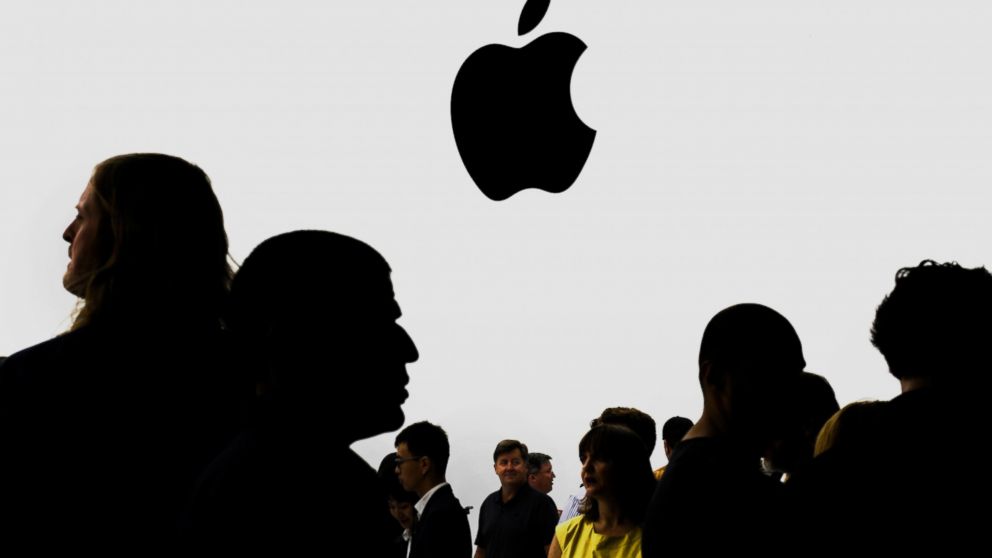 The silhouettes of attendees are seen after a product announcement at Flint Center in Cupertino, Calif., Sept. 9, 2014.