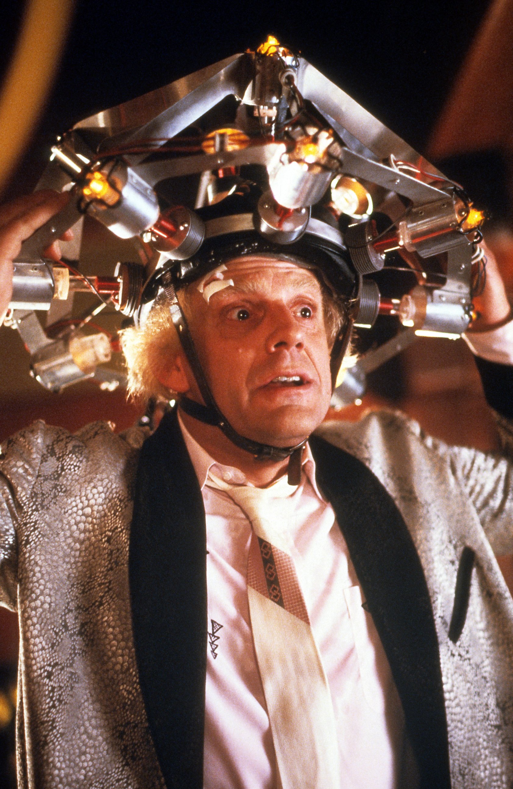 PHOTO: Christopher Lloyd wearing concoction on his head in a scene from the film 'Back To The Future', 1985.