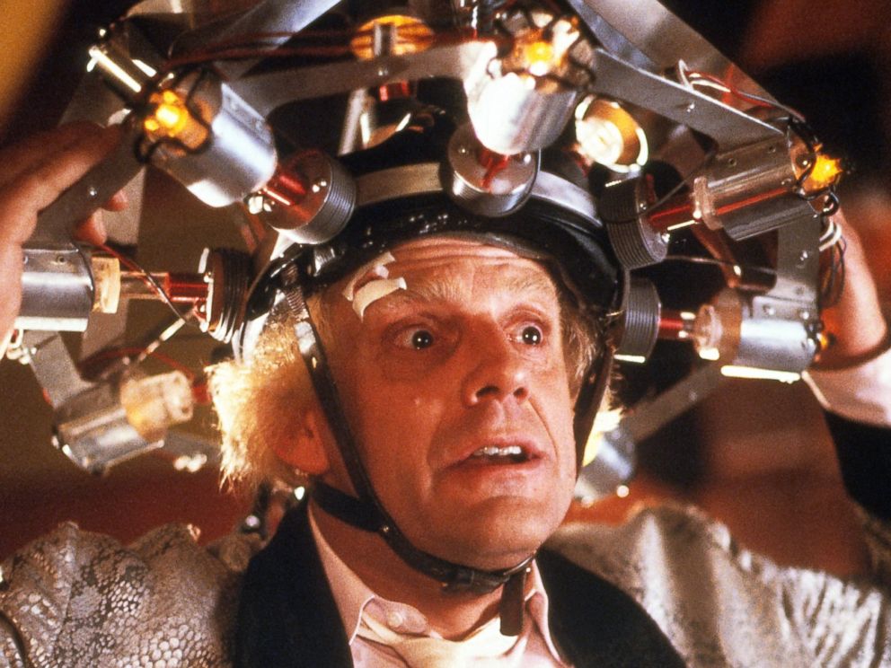 PHOTO: Christopher Lloyd wearing concoction on his head in a scene from the film Back To The Future, 1985.