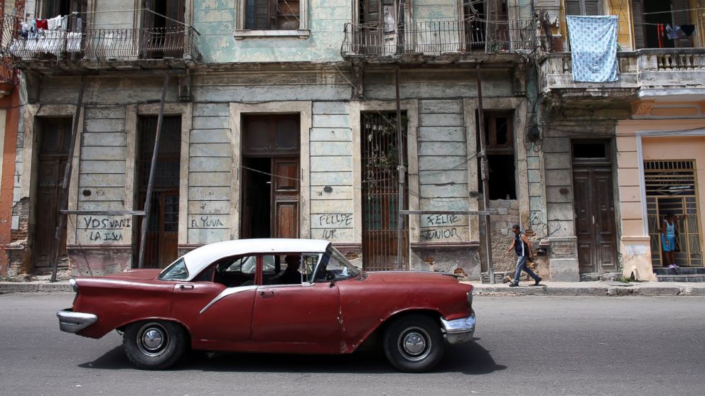 A vinatge American car is driven past colonial era buildings, Sept. 17, 2015, in Havana.