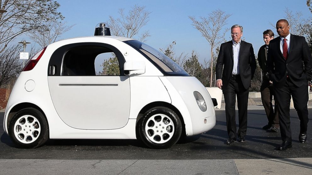 U.S. Transportation Secretary Anthony Foxx, right, and Google Chairman Eric Schmidt, left, walk around a Google self-driving car at the Google headquarters on Feb. 2, 2015 in Mountain View, Calif.