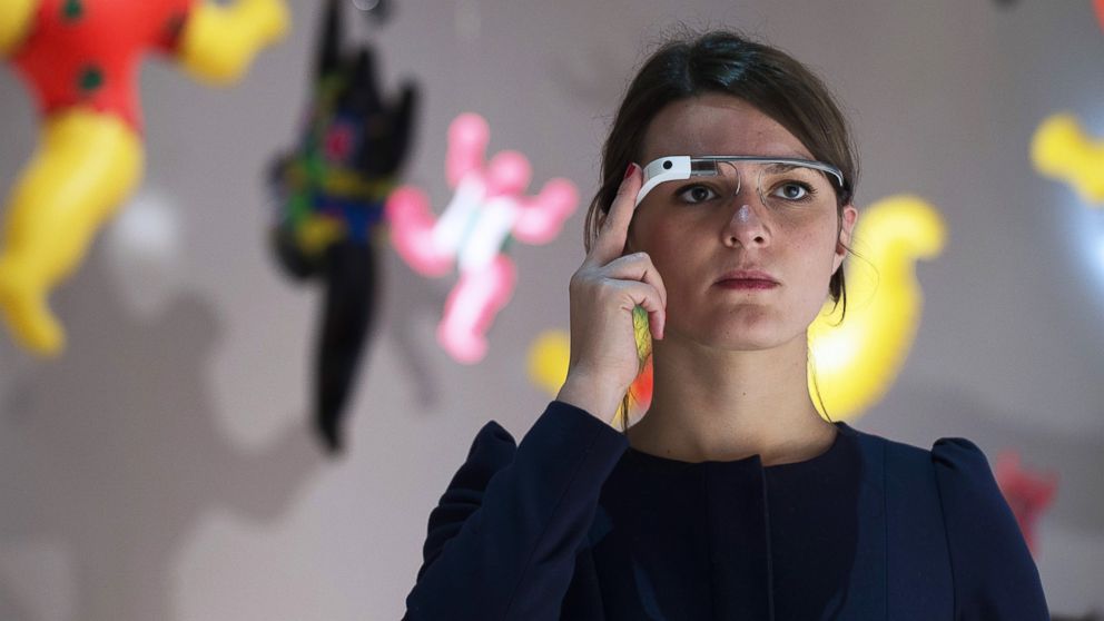 A woman wears Google Glass as she visits an exhibition dedicated to the work of French artist Niki de Saint Phalle at the Grand Palais in Paris on Nov. 6, 2014. 