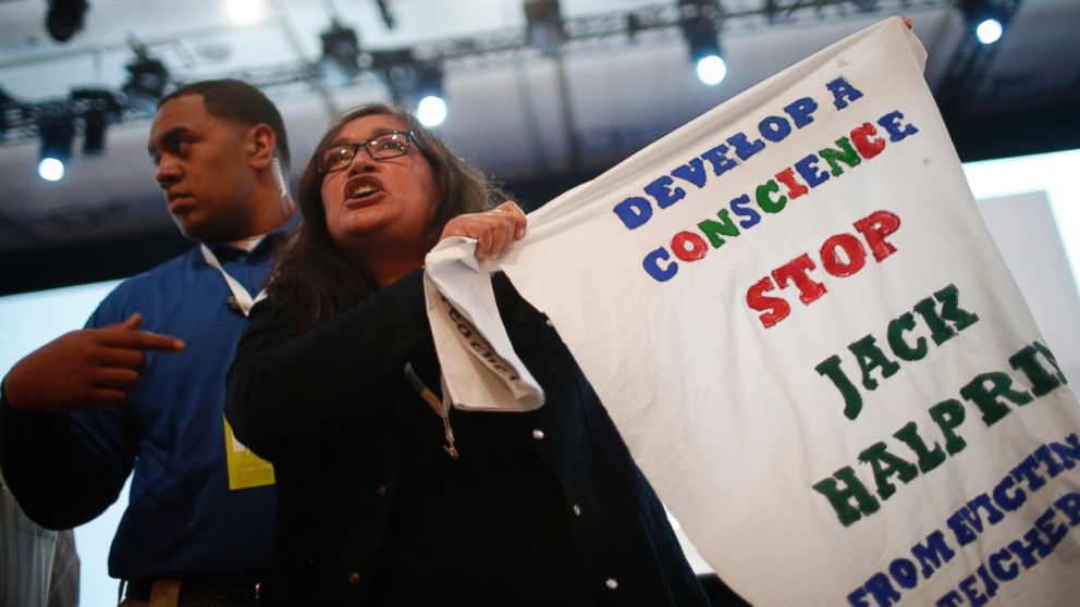 A demonstrator waves a sign in protest of Google during the Google I/O Developers Conference at Moscone Center, June 25, 2014 in San Francisco, Calif.