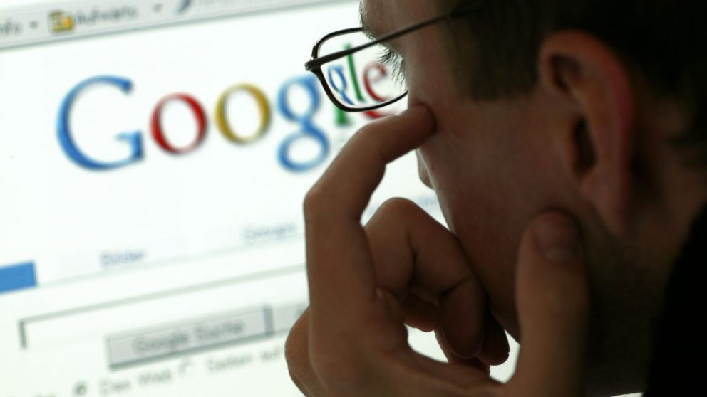 A man is seen in front of a display with the website of the internet search engine Google in this undated file photo. 