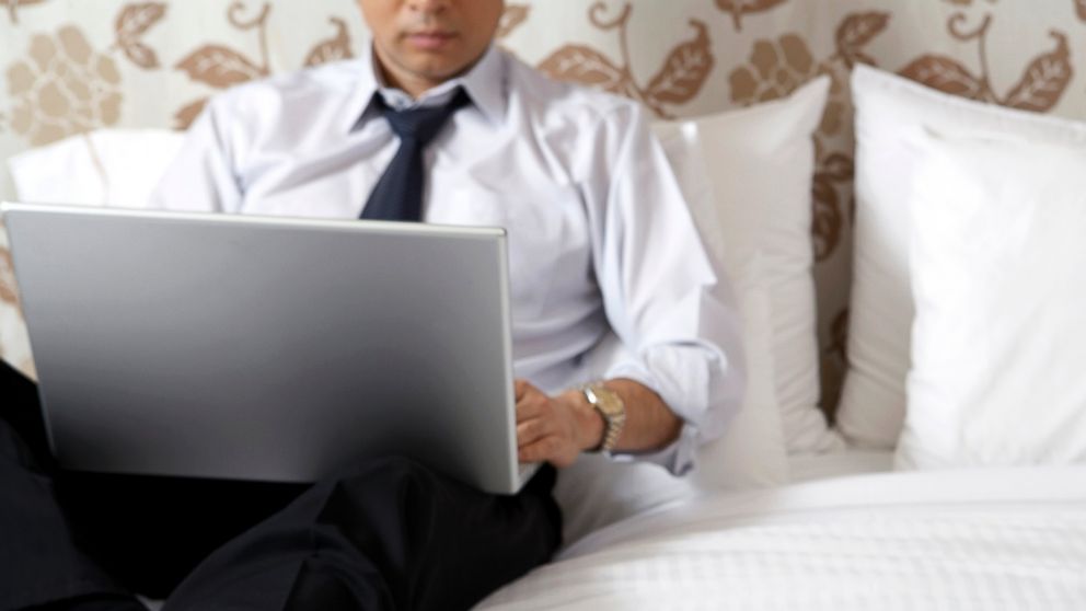 A businessman is pictured in his hotel room in this stock image. 