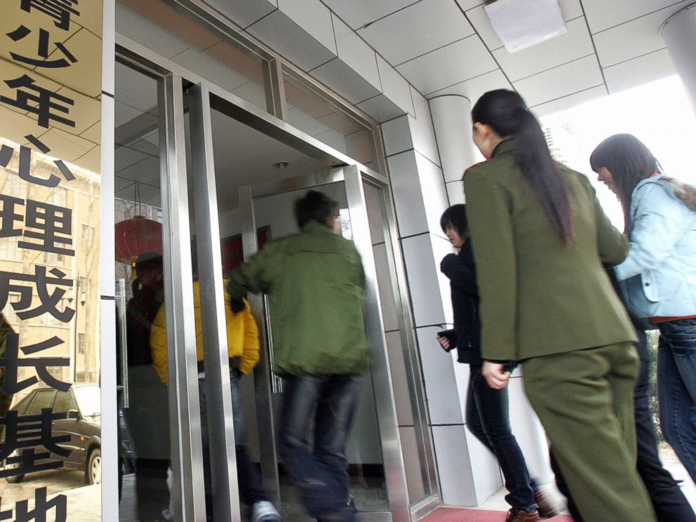 PHOTO: Teenagers make their way into the Internet Addiction Treatment Centre in the southeastern suburb of Daxing, near Beijing, China on March 1, 2007.