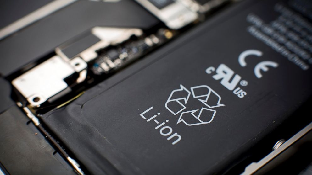A lithium-ion battery, seen in this file photo, sits inside a smartphone sold as an Apple Inc. iPhone 4S in an arranged photograph in Hong Kong, Jan. 11, 2014.