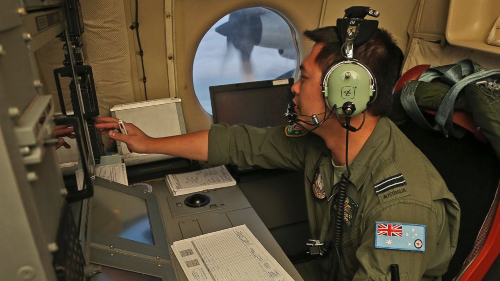 PHOTO: Flight Officer Jack Chen mans the navigation and comms station on board a Royal Australian Air Force AP-3C Orion as they search for debris or wreckage of missing Malaysian Airlines flight MH370, March 22, 2014.