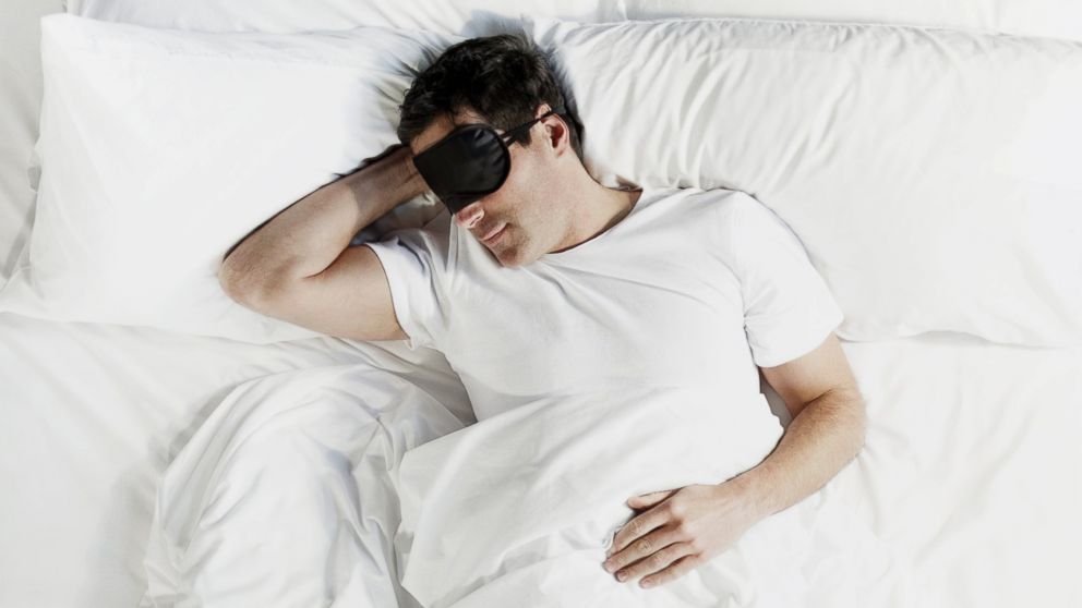 A man sleeps wearing an eye mask in this undated stock photo.