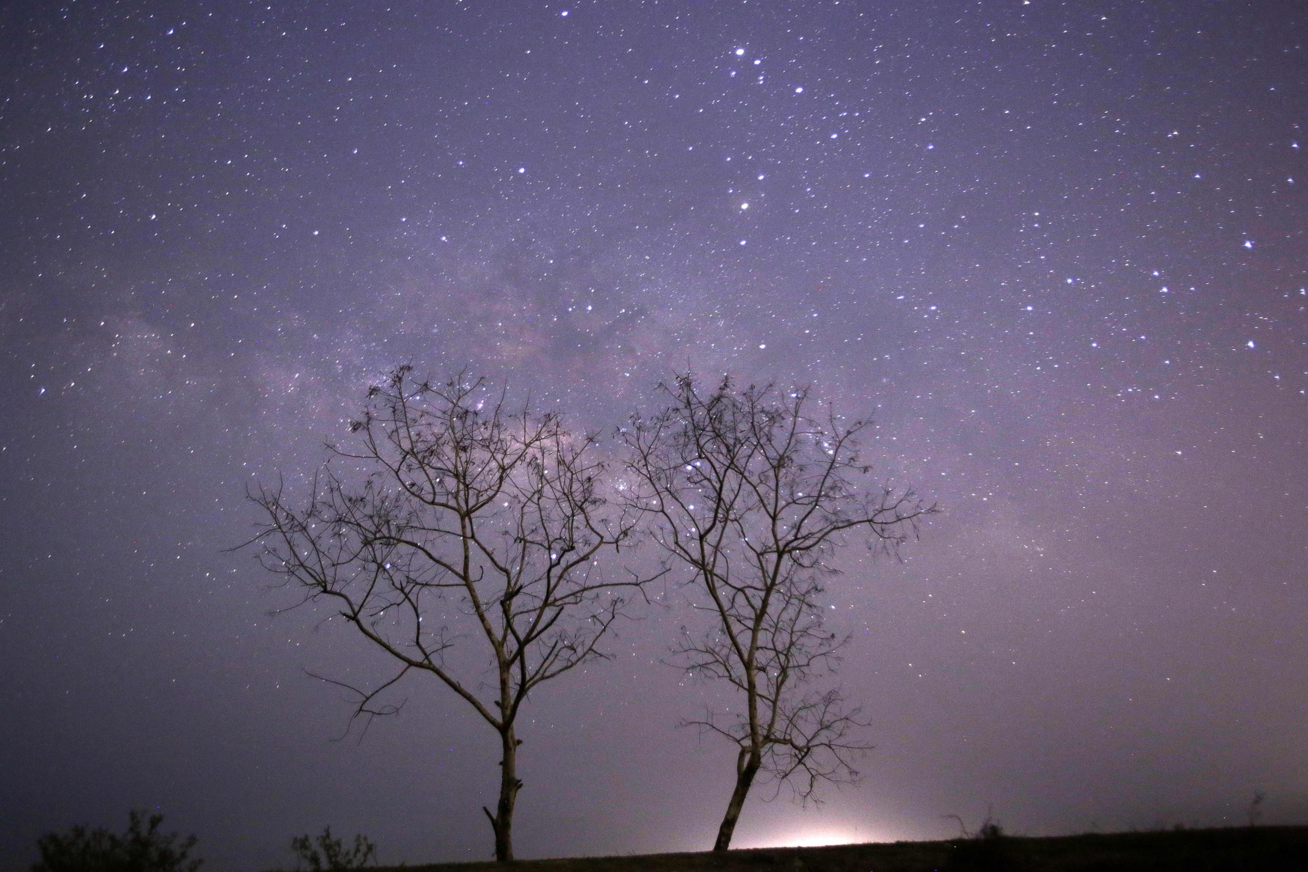 PHOTO: This long-exposure photograph taken on Earth Day shows the Lyrids meteor shower passing near the Milky Way in the clear night sky of Thanlyin, nearly 14 miles away from Yangon on April 23, 2015.