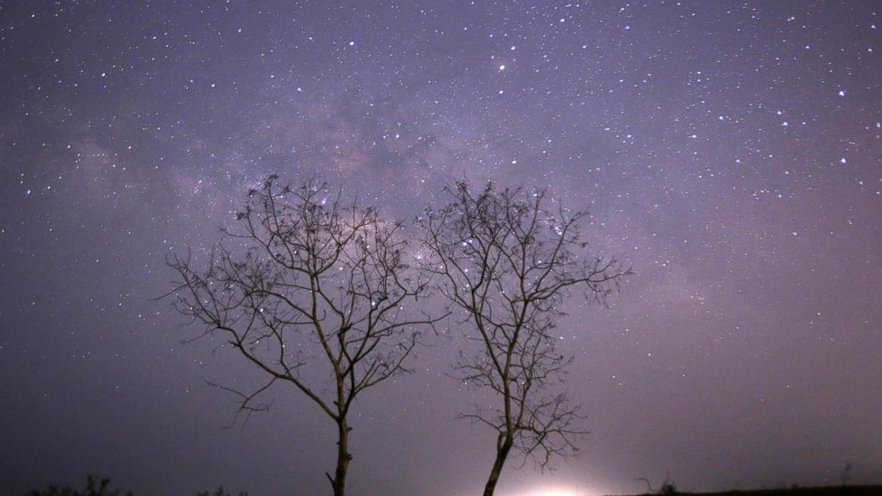 PHOTO: This long-exposure photograph taken on Earth Day shows the Lyrids meteor shower passing near the Milky Way in the clear night sky of Thanlyin, nearly 14 miles away from Yangon on April 23, 2015.