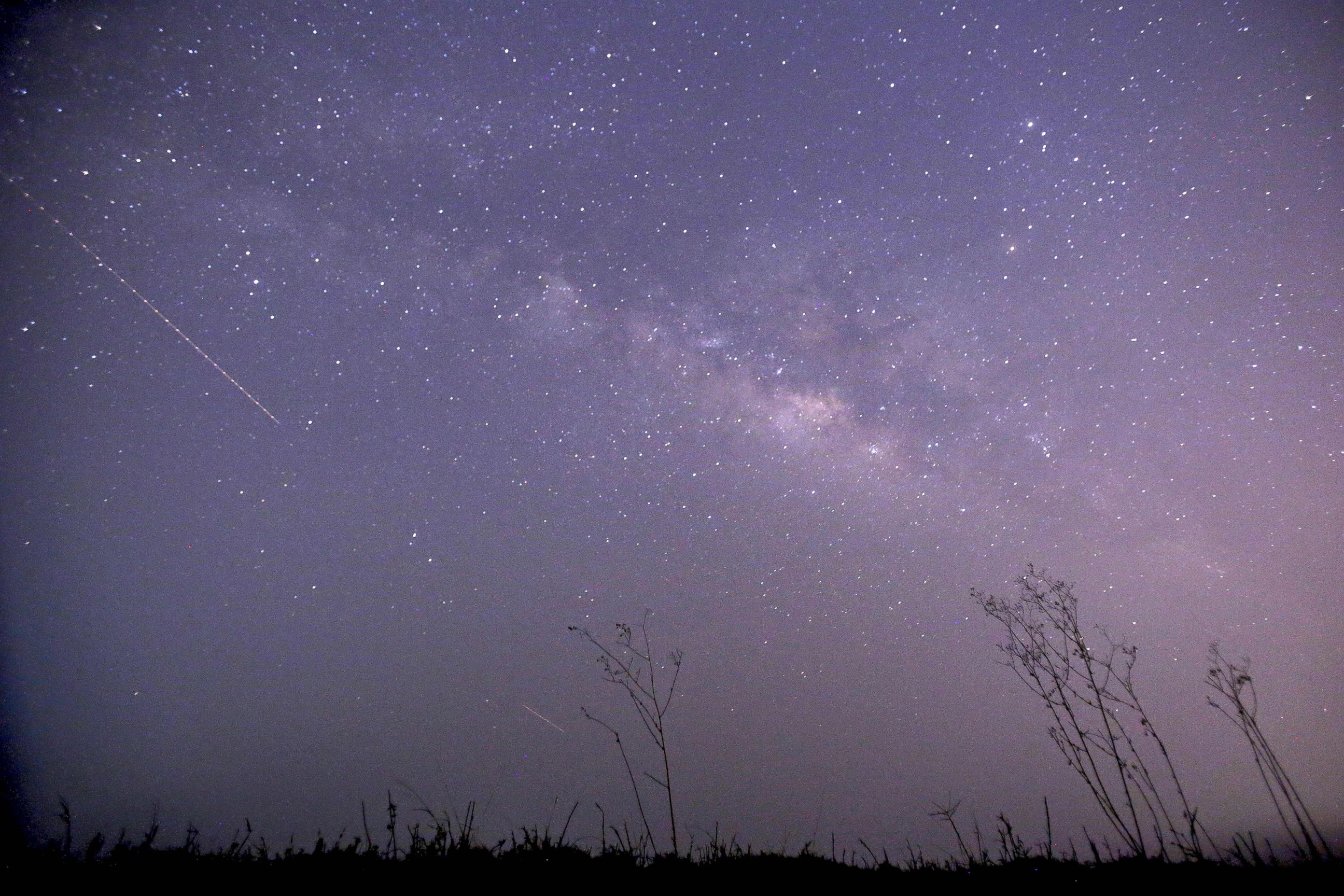PHOTO: This long-exposure photograph taken on Earth Day shows the Lyrids meteor shower passing near the Milky Way in the clear night sky of Thanlyin, nearly 14 miles away from Yangon on April 23, 2015. 