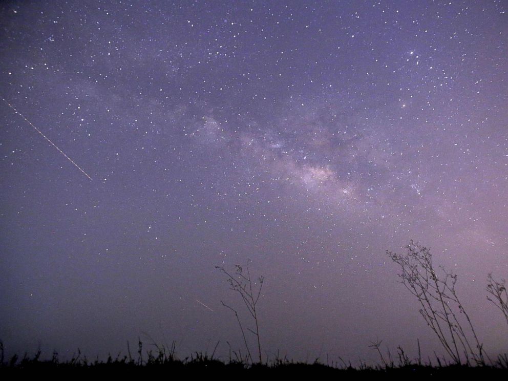 PHOTO: This long-exposure photograph taken on Earth Day shows the Lyrids meteor shower passing near the Milky Way in the clear night sky of Thanlyin, nearly 14 miles away from Yangon on April 23, 2015.