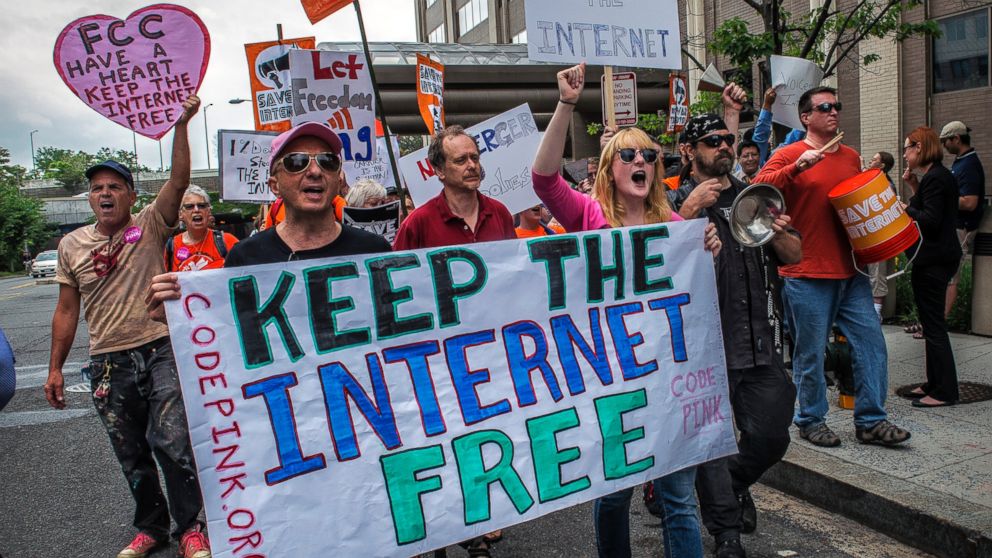 PHOTO: Protesters march past the FCC headquarters before the Commission meeting on net neutrality proposal on May, 15, 2014 in Washington.